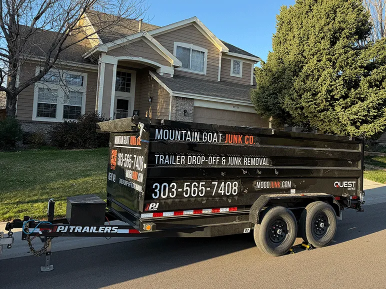 Mountain Goat Junk Co. dump trailer parked at a Denver Metro home, ready for junk removal